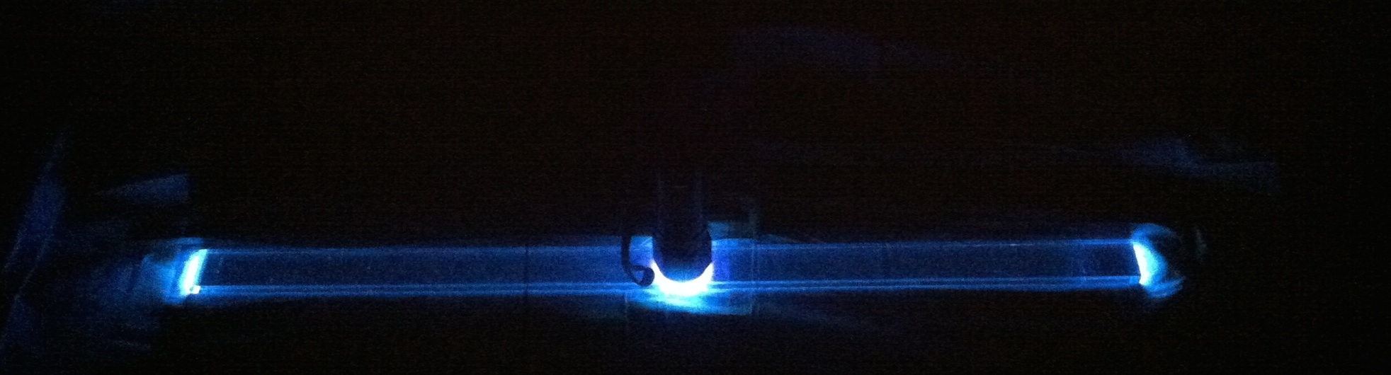 A
  lightguide illuminated in the middle with a UV flashlight